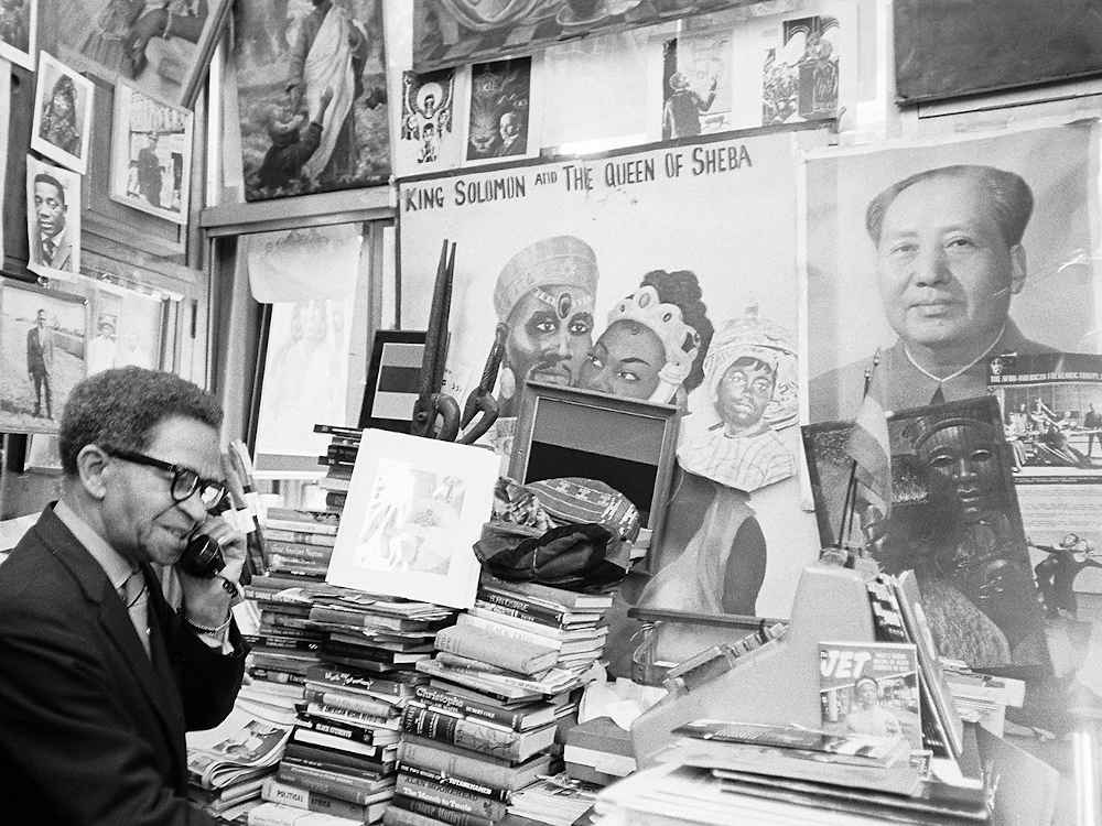 Black Panthers founder Huey Newton at his desk with Mass Murderer Mao Zedong