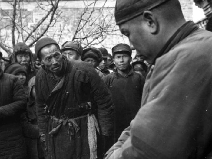 A struggle session during the Great Leap Forward. A landlord is subjected to public ridicule and criticism by those who know him, circa 1950-1955