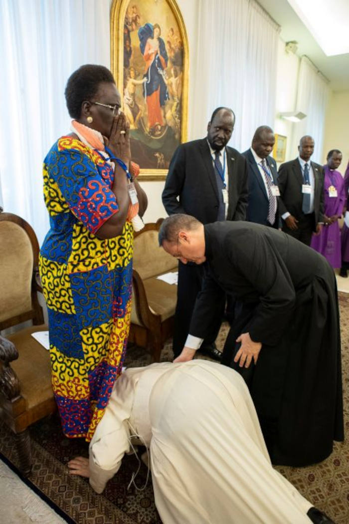 pope on his hands and knees kissing the feet of sudanese political leaders