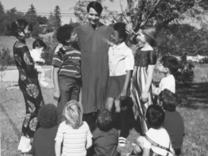 Revered Jim Jones surrounded by his Multicultural Rainbow Family